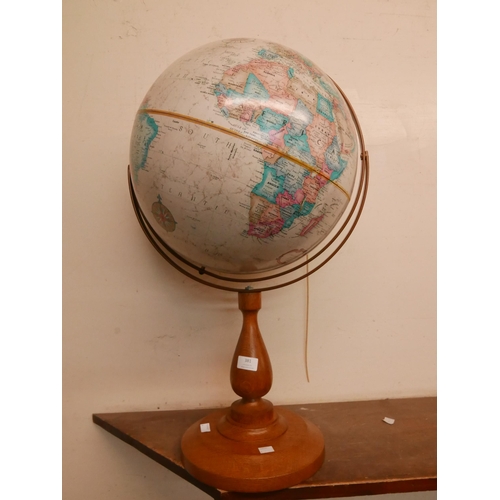 381 - A desk top terrestrial globe, on oak stand