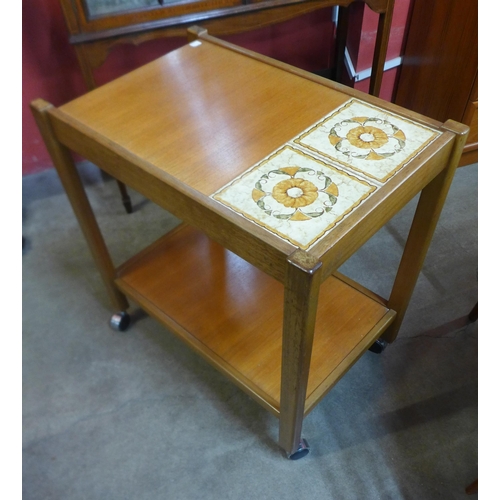 47 - A G-Plan teak chest of drawers and a teak and tiled top two tier trolley