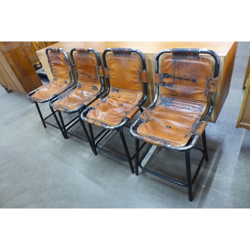 56 - A set of four Les Arc style black tubular metal and brown leather ski chalet chairs, after Charlotte... 