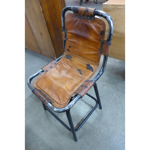 56 - A set of four Les Arc style black tubular metal and brown leather ski chalet chairs, after Charlotte... 