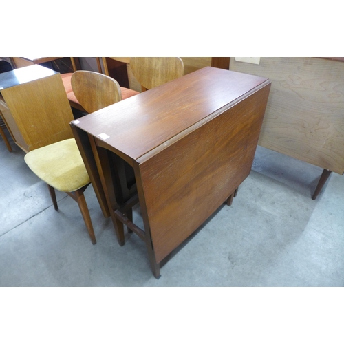 66 - A teak drop leaf dining table and four chairs