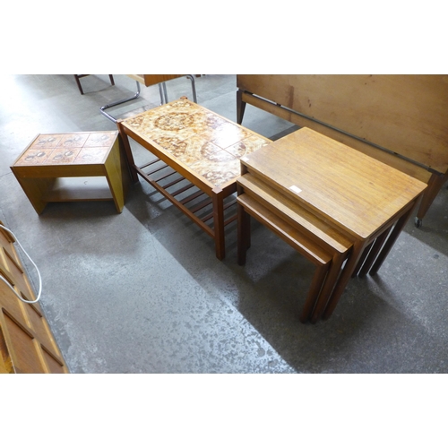 68 - A teak nest of tables and two teak and tiled top coffee tables