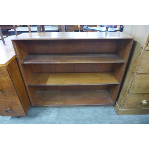 74 - A teak open bookcase, a bedside cabinet and a blanket box