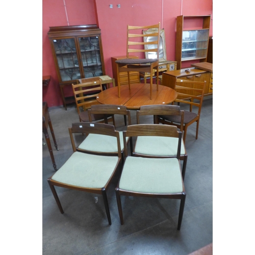 79 - A G-Plan teak extending dining table, a/f and seven teak dining chairs