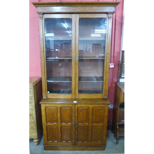 85 - A Victorian Aesthetic Movement carved oak four door bookcase