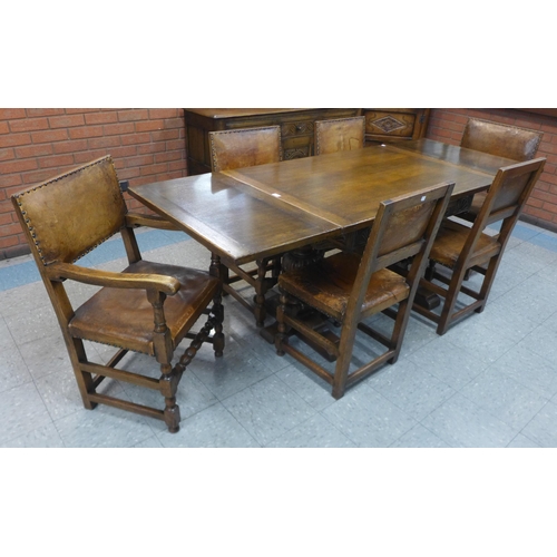 89 - A 17th Century style carved oak draw-leaf refectory table and six chairs