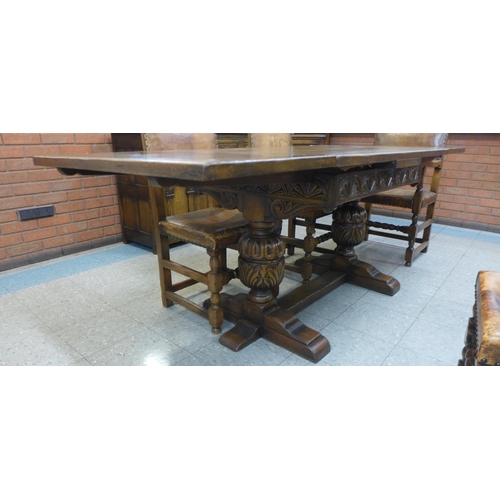 89 - A 17th Century style carved oak draw-leaf refectory table and six chairs