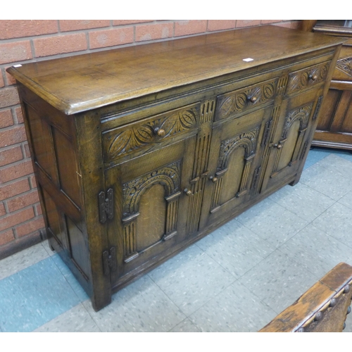 90 - A 17th Century style carved oak sideboard