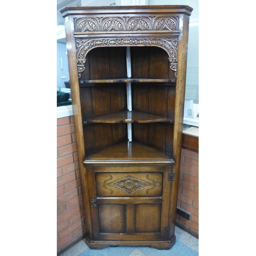 91 - A 17th Century style carved oak freestanding corner cupboard