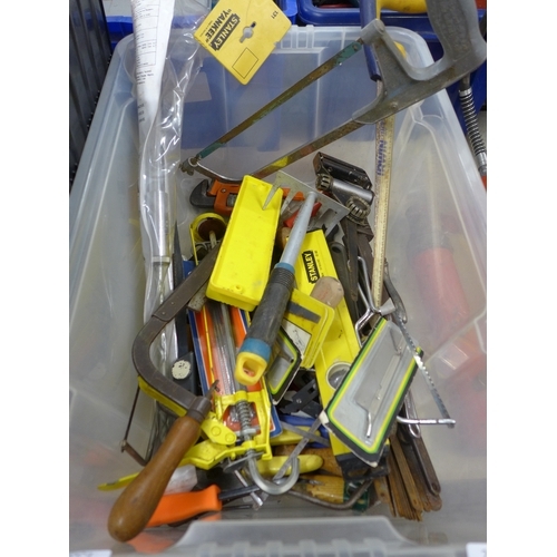 2028 - A plastic storage box containing an assortment of tools including a Record bench vice, saw blades, h... 