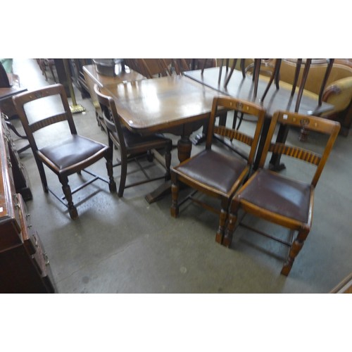 119 - An oak six piece dining suite, comprising; draw-leaf table, four chairs and a sideboard