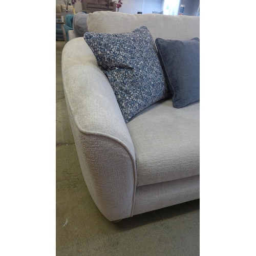 1321 - An ivory velvet three seater sofa with contrasting scatter cushions