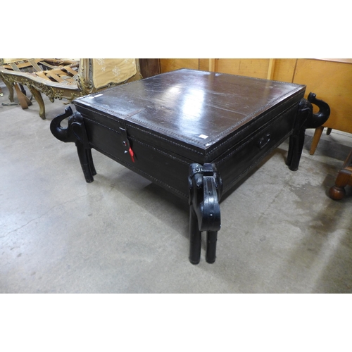 144 - An African ebonised and iron mounted coffee table