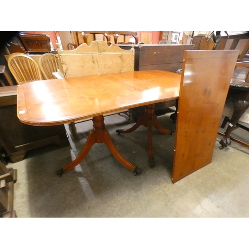 236 - A yew wood pedestal dining table, a display cabinet and a corner cabinet