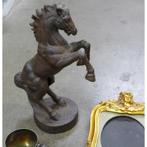 1091 - A cast metal model of a rearing horse, gilt picture frame, glass model of a cat, a gilt and glass cl... 