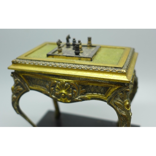 607 - A cast metal table vesta in the form of French Louis XI style table with chessboard and chess pieces... 