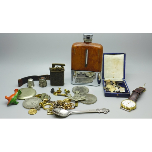 612 - A hip flask, crowns, watch badges, etc.