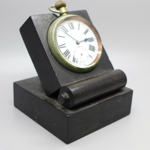 619 - A military issue pocket watch on a black stand, marked Patt. 300, 4141, with broad arrow