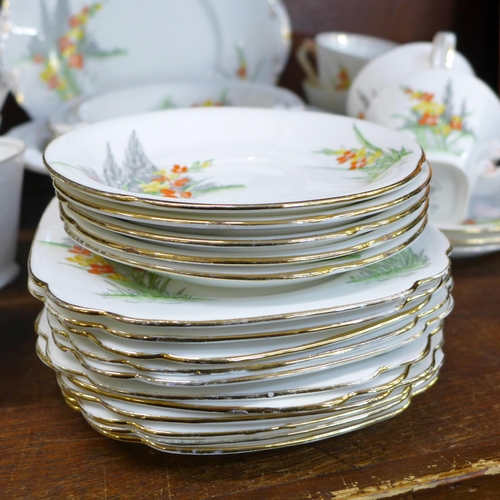 660 - An Art Deco tea service, eight cups and saucers, eleven side plates, a large plate and a matching fr... 