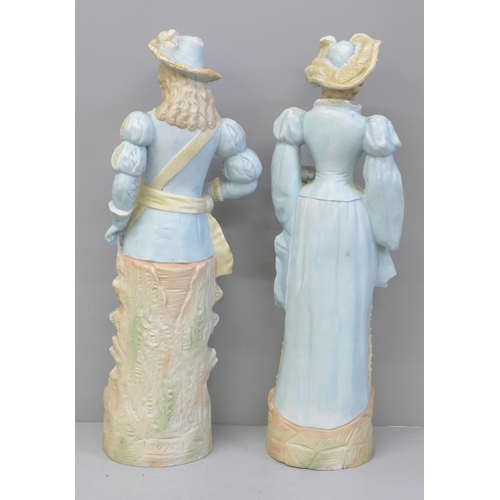 670 - A pair of German bisque figures, hat on gentleman a/f, chipped