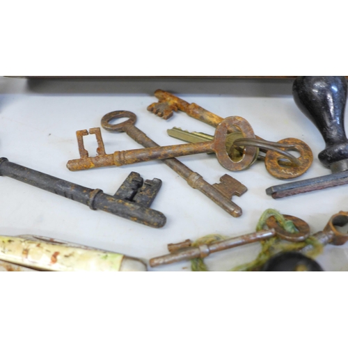 687 - Antique door keys, desk stamps, watch tools, etc., and a cased set of brass typesetting rules