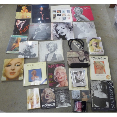 710 - A box of paperback books on Marilyn Monroe and other Marilyn Monroe items including a mug, calendars... 