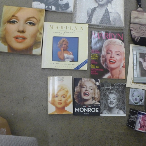 710 - A box of paperback books on Marilyn Monroe and other Marilyn Monroe items including a mug, calendars... 