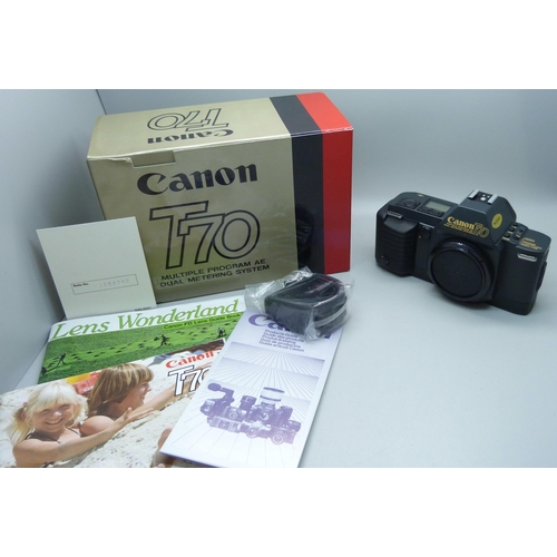 728 - Two Canon cameras; T50 and T70, a collection of accessories including a 70-210 zoom lens, a 244T Spe... 