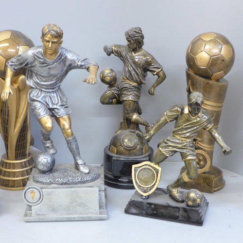 729 - Eight large football trophies including six footballers in action