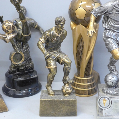 729 - Eight large football trophies including six footballers in action