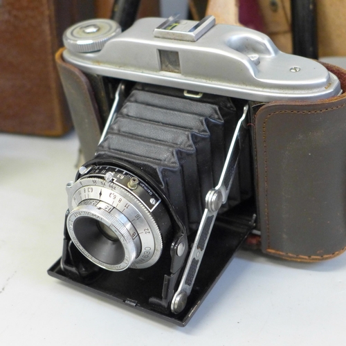 767 - A Kershaw 630 camera, a Kodak folding camera, two tripods, etc.