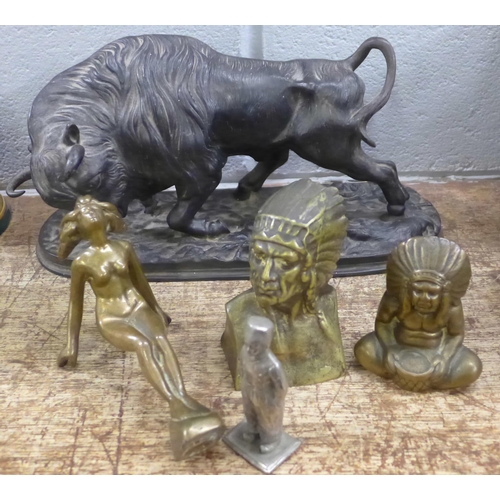 805 - A cast iron bull, 35cm wide, a car mascot type figure and three other figures