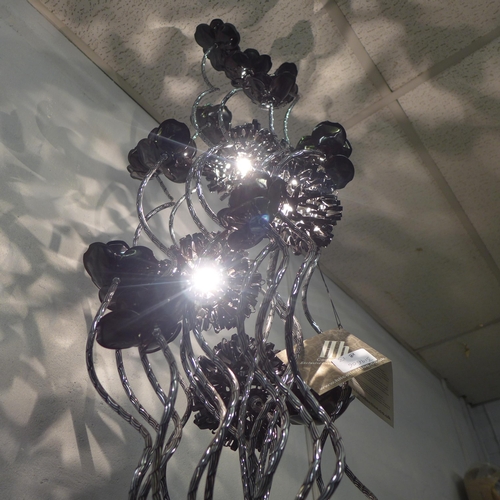 1340 - A silver and black floral lamp