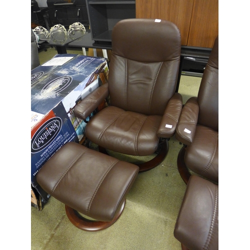 1596 - A brown leather reclining chair and footstool