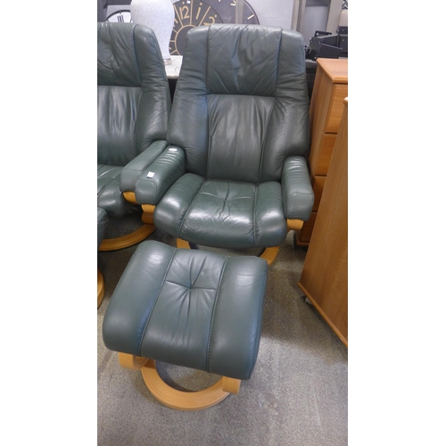 1599 - A green leather reclining chair and footstool