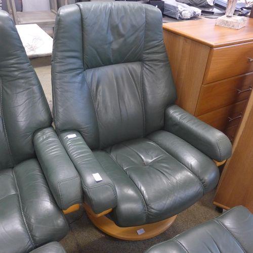 1599 - A green leather reclining chair and footstool