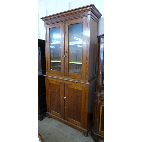 100 - A Victorian pitch pine bookcase, with brushing slide