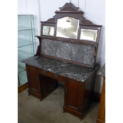 104 - An Edward VII walnut and marble topped mirror back sideboard/desk