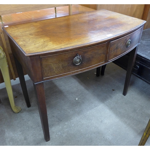 142 - A George III mahogany bow front two drawer side table