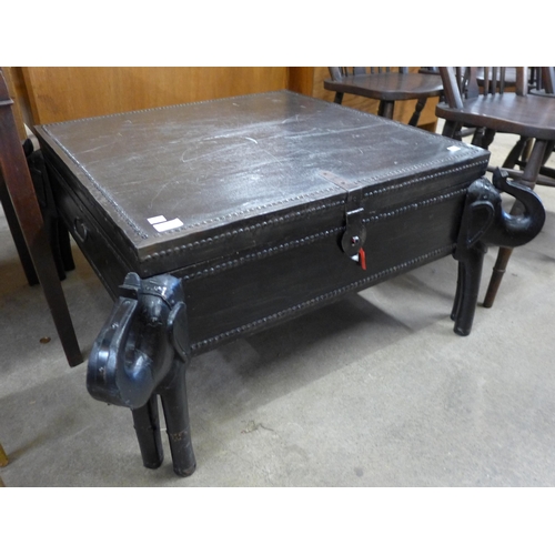 144 - An African ebonised and iron mounted coffee table