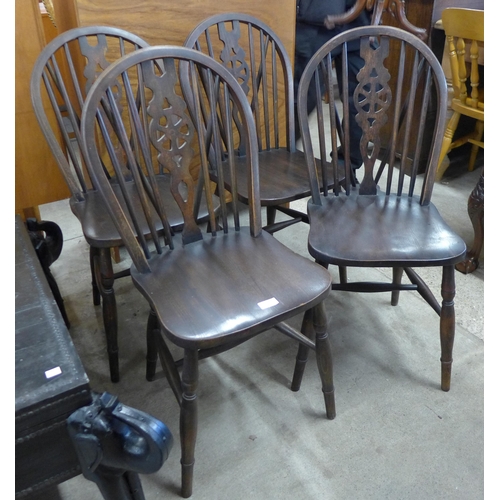 145 - A set of four beech wheelback kitchen chairs