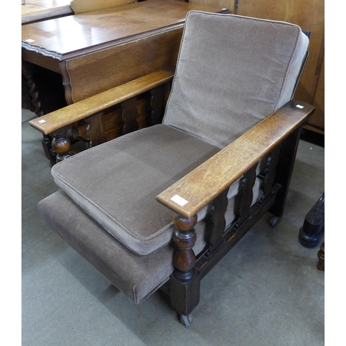 148 - An Arts and Crafts oak reclining armchair