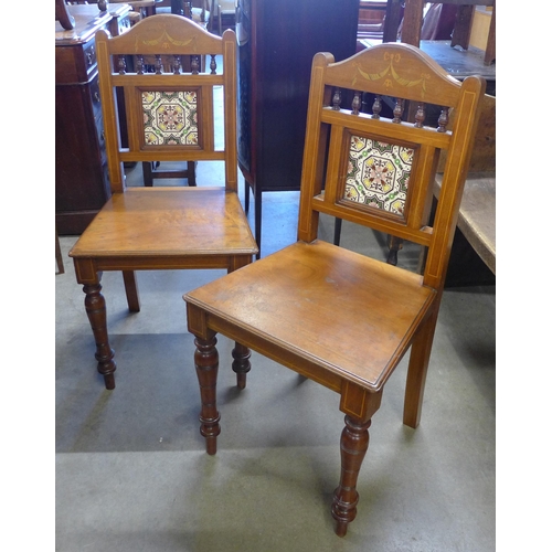 151 - A pair of Victorian Aesthetic Movement inlaid walnut and tiled back hall chairs