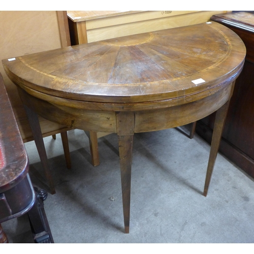 152 - A George III inlaid walnut demi-lune fold over card table