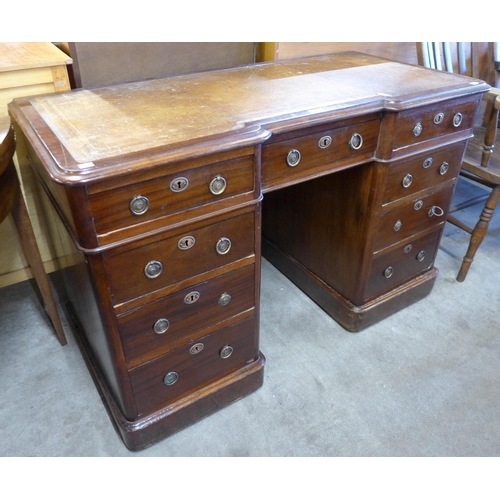 154 - A Victorian mahogany and tan leather topped inverted breakfront pedestal desk