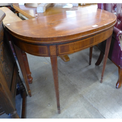 167 - A George III inlaid mahogany demi-lune fold over card table