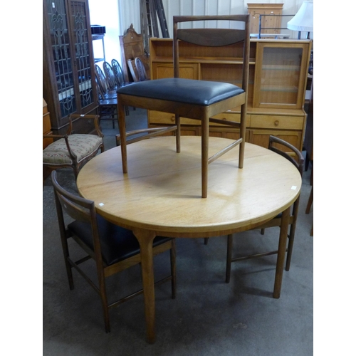 17 - A McIntosh teak circular extending dining table and four chairs