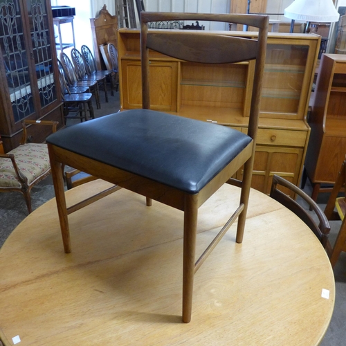 17 - A McIntosh teak circular extending dining table and four chairs