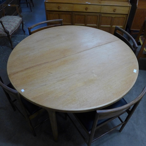 17 - A McIntosh teak circular extending dining table and four chairs