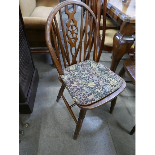 194 - A set of six oak and beech wheelback chairs